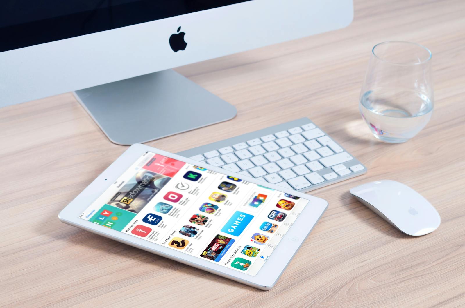 Sleek home office setup featuring an iMac and iPad showcasing apps.